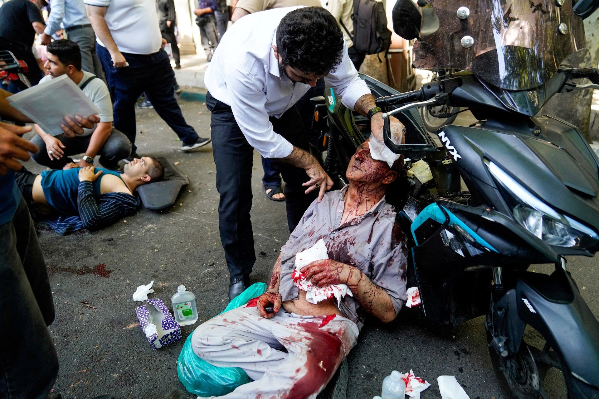 People help casualties on the floor following the Israeli strikes on Iran, in Tehran, June 15. 