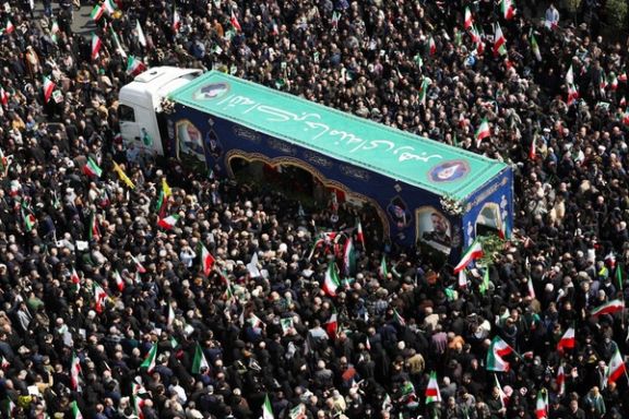 People gather around the coffin of Iranian security chief Ali Larijani during a funeral for Larijani and victims of the IRIS Dena warship, in Tehran, Iran, March 18,