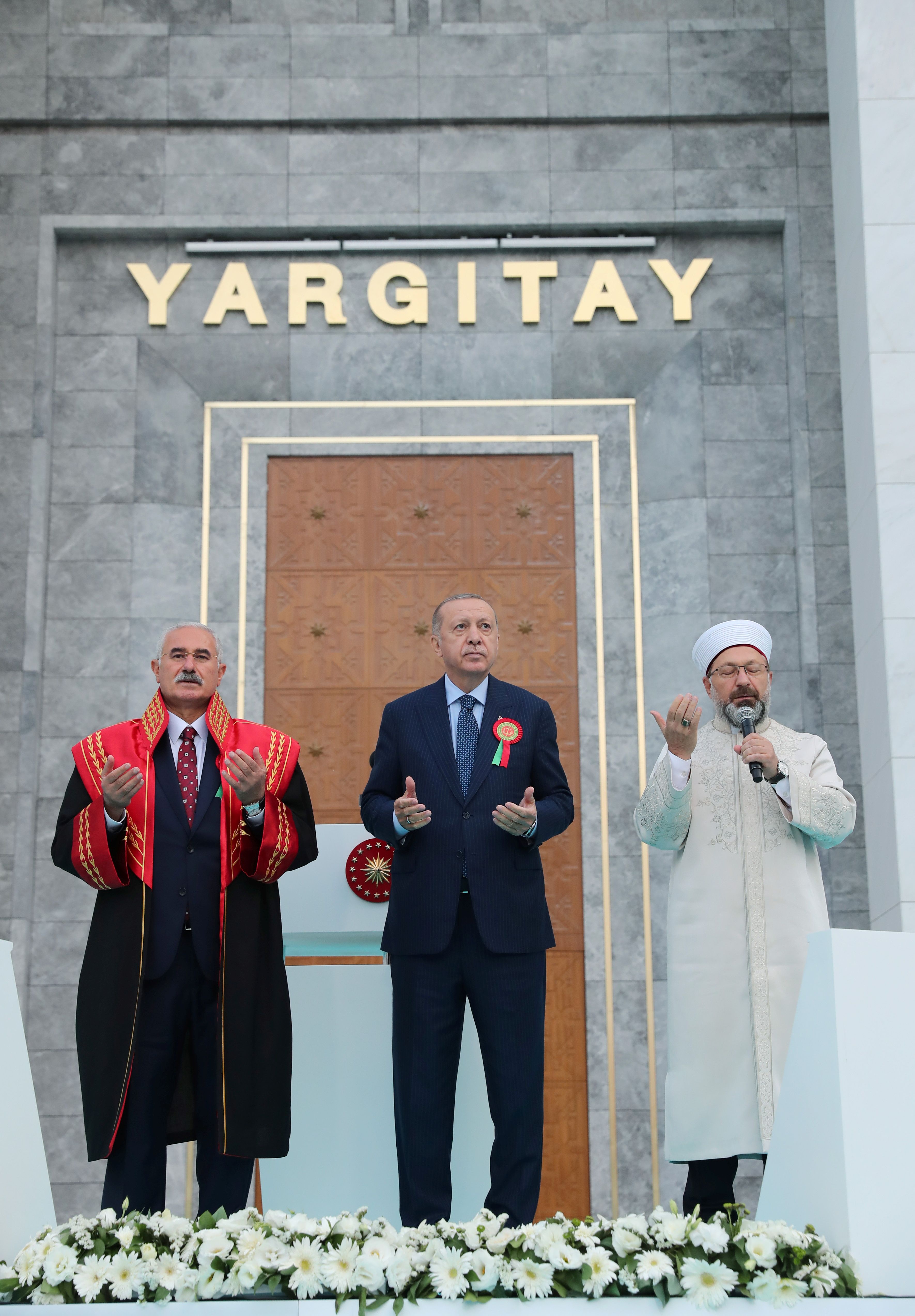 President Tayyip Erdogan and Head of Turkey's Directorate of Religious Affairs Ali Erbas pray as they stand next to the President of Court of Cassation Mehmet Akarca during the opening ceremony of a top judicial court building in Ankara, Turkey, September 1, 2021