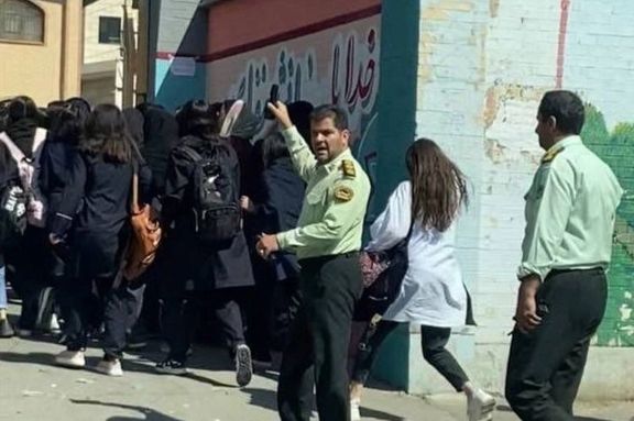 Police officers trying to control schoolgirls protesting against the Islamic Republic. Oct. 4, 2022