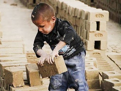 An Iranian child working at a brick factory