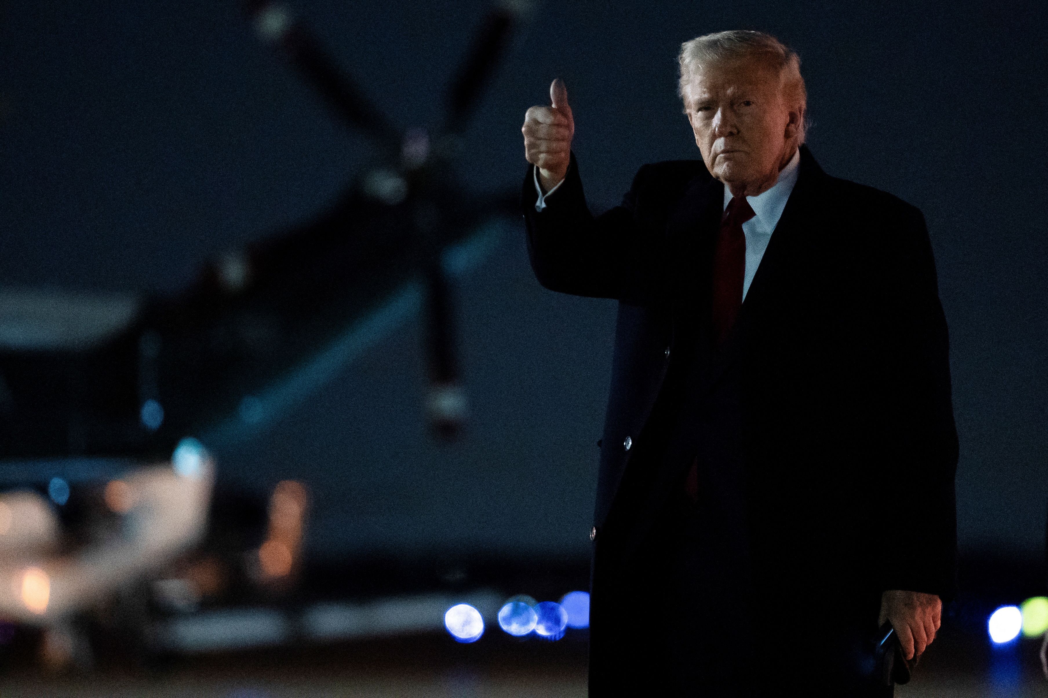 US President Donald Trump gestures as he arrives at Joint Base Andrews in Maryland, April 13, 2025.