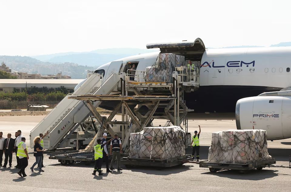Workers unload medical supplies delivered by the World Health Organization for any potential health crisis resulting from hostilities, in Beirut, Lebanon, August 5, 2024.