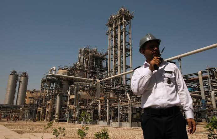 A security person stands in front of the Mahshahr petrochemical plant in Khuzestan province,1032 km (641 miles) southwest of Tehran, September 28, 2011. 