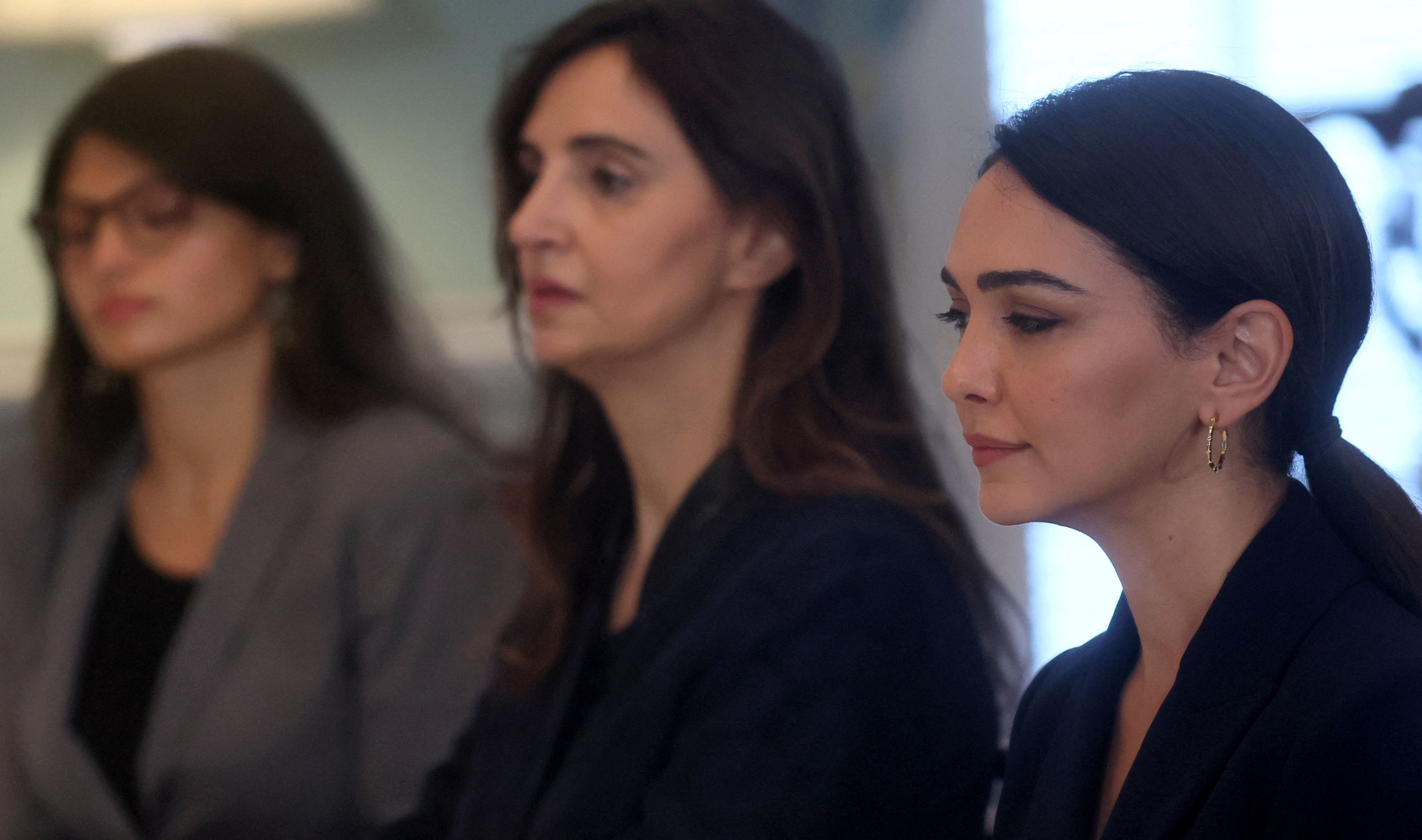 British-Iranian actress and activist Nazanin Boniadi (right), Iranian-American writer Roya Hakakian (center) and Iranian-American activist Sherry Hakimi listen as US Secretary of State Antony Blinken (not pictured) speaks during a meeting at the State Department in Washington on October 14, 2022. 