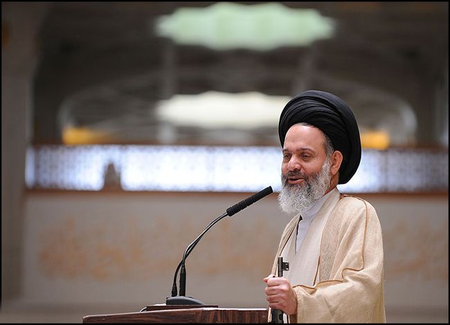 Ayatollah Hashemi Bushehri, holding a gun during a Friday sermon, as is customary for Islamic Republic.