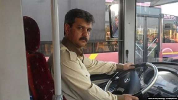 Reza Shahabi driving a city bus in Tehran. Undated