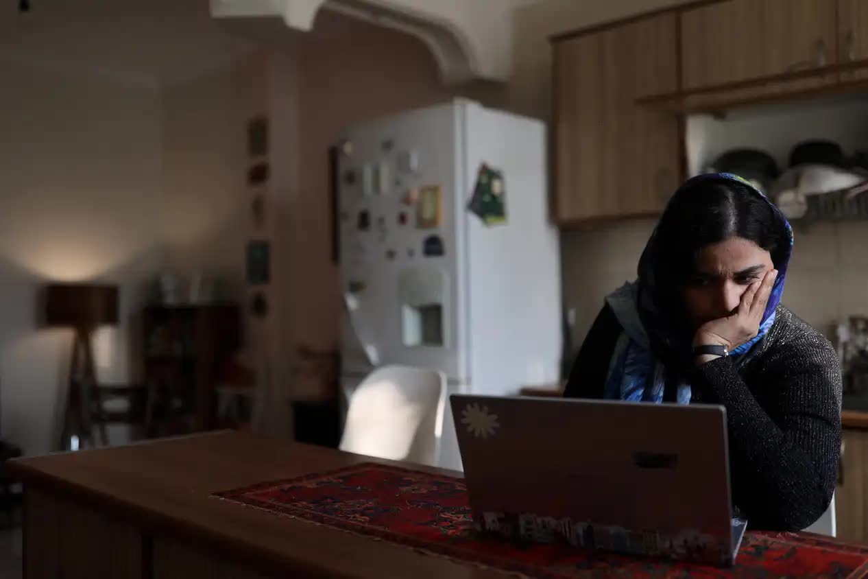 A woman uses her laptop at home as Iran’s internet shutdown persists, leaving millions offline.