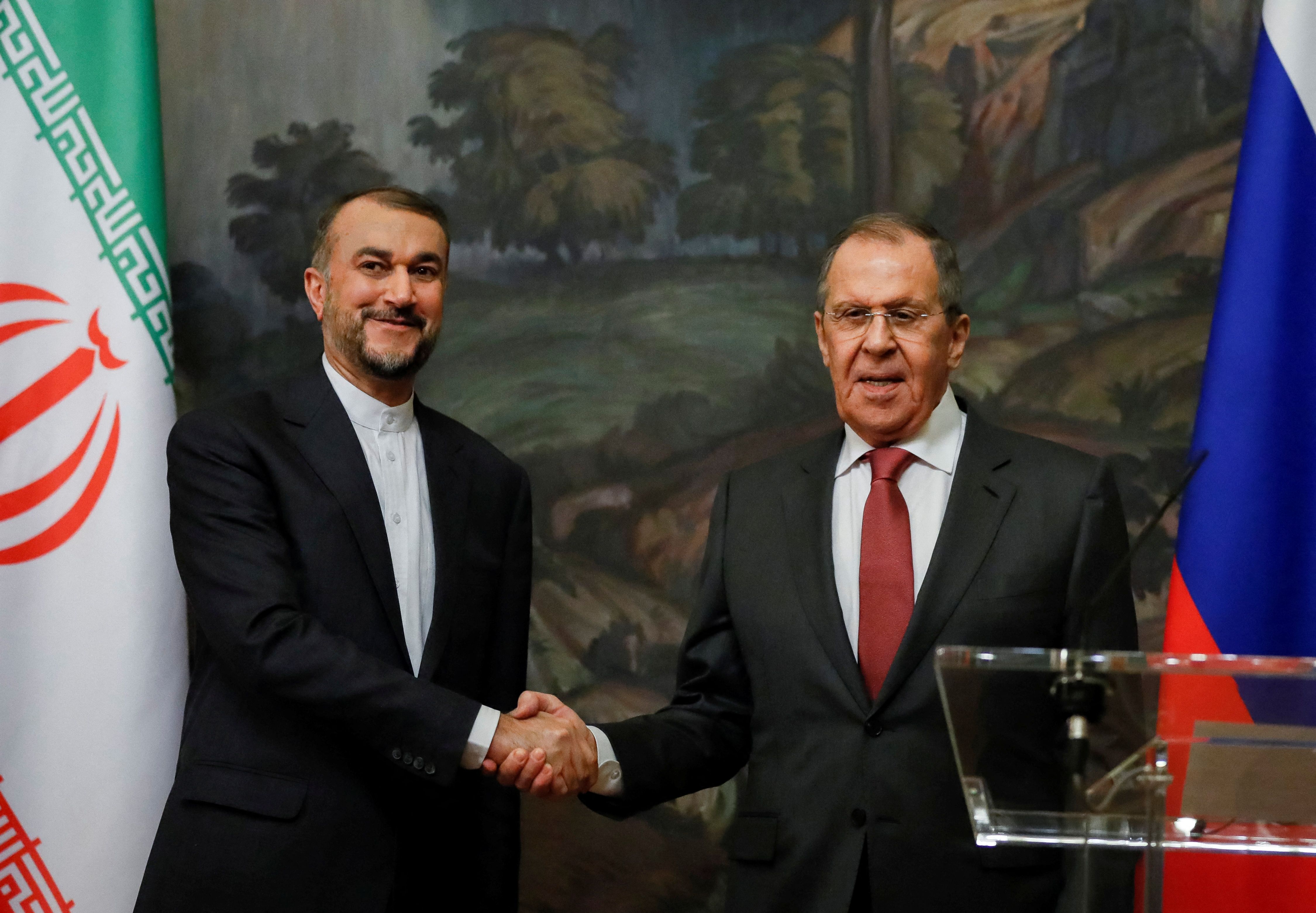Russian Foreign Minister Sergei Lavrov shakes hands with Iranian Foreign Minister Hossein Amir-Abdollahian during a news conference following their meeting in Moscow, Russia March 29, 2023. 