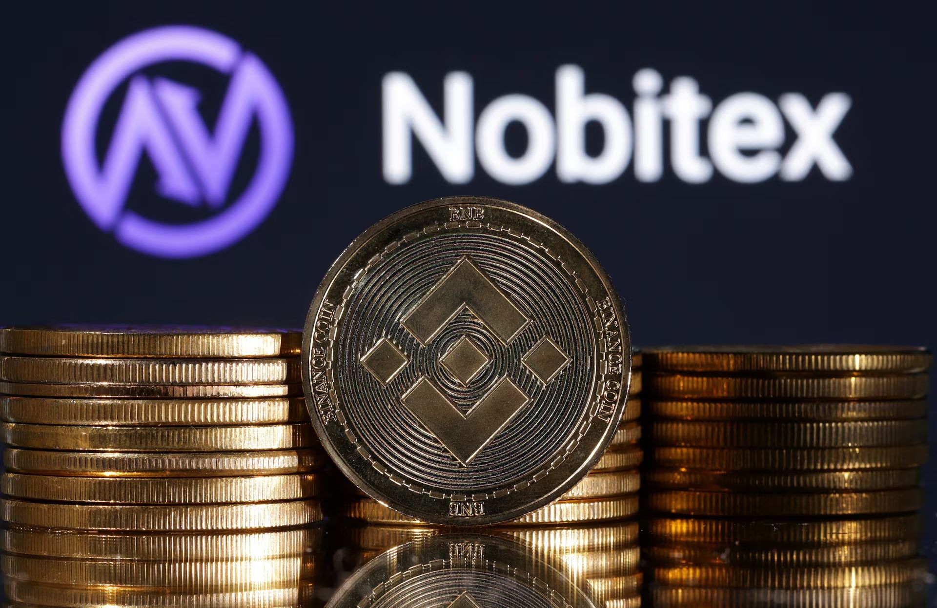  Representations of cryptocurrency Binance are seen in front of displayed Nobitex logo in this illustration taken November 3, 2022.