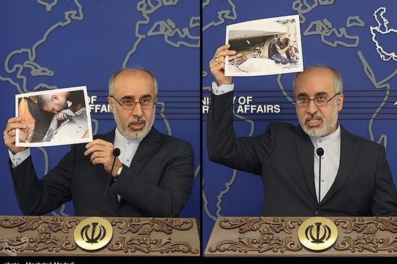 Foreign Ministry spokesman Naser Kanaani holding photos of the aftermath of the bombing on Gaza during a press conference on October 16, 2023