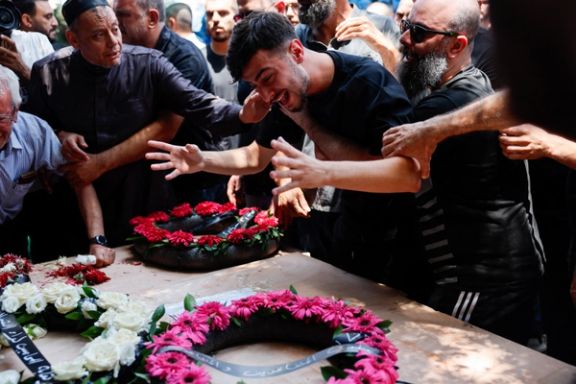 A man reacts as relatives and friends attend the funeral of Manar Khatib and her two daughters, Hala, 20, and Shada, 13, and their relative, Manar Khatib who were killed during a missile attack from Iran on Israel, in Tamra, north Israel June 17, 2025