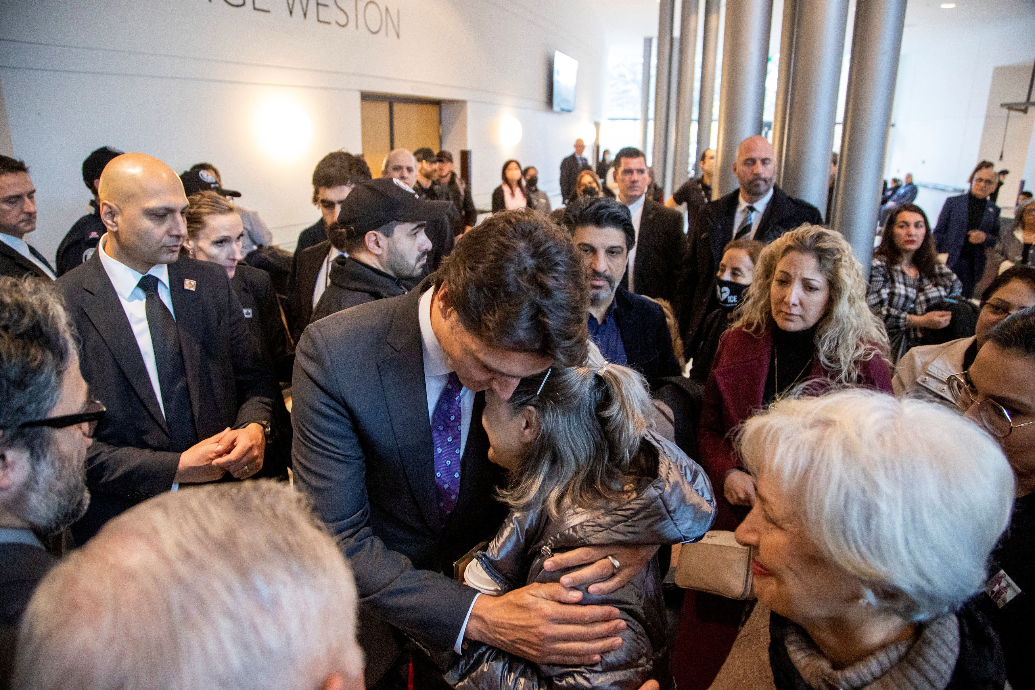 Canada's Prime Minister Justin Trudeau hugs Tourane Shamsolahi, the relative of victims, at an event marking the third anniversary of the downing of Ukraine International Airlines flight PS752, in Toronto, Ontario, Canada January 8, 2023. 