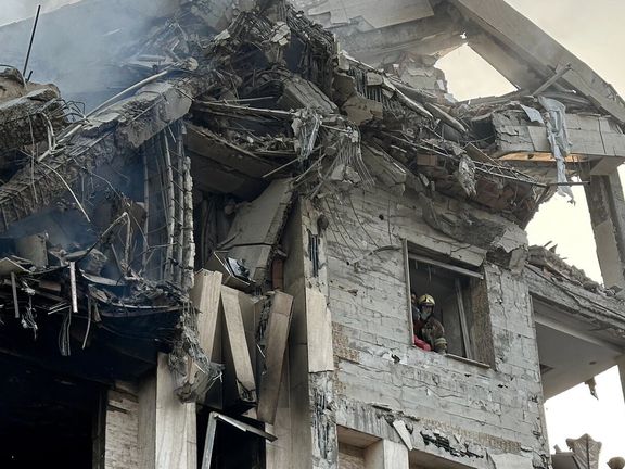 A firefighter looks out of a building impacted by Israeli strikes, Tehran, Iran, June 14, 2025