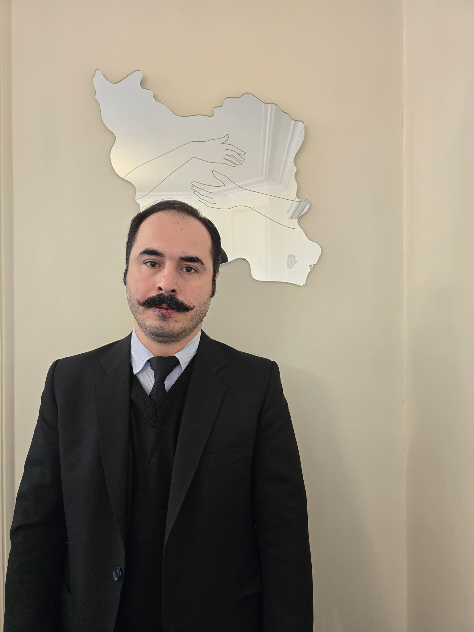 Outspoken Iranian activist sews lips shut, stages silent sit-in