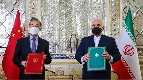 Iran’s former foreign minister Mohammad Javad Zarif (right) and China’s foreign minister Wang Yi during the signing ceremony of Iran-China strategic cooperation agreement in Tehran on March 27, 2021