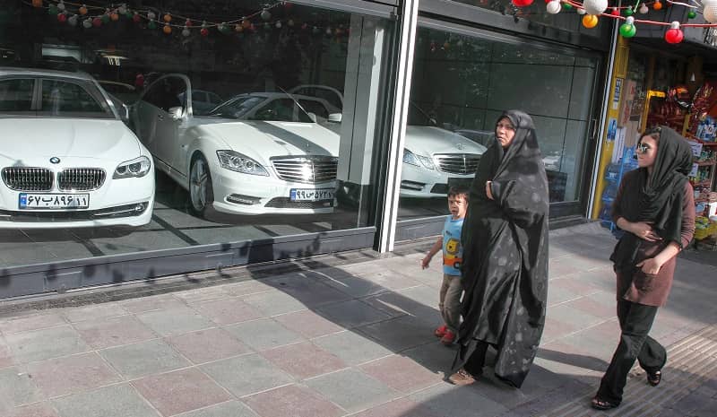 People passing by a shop for luxury cars in Tehran  (file photo)
