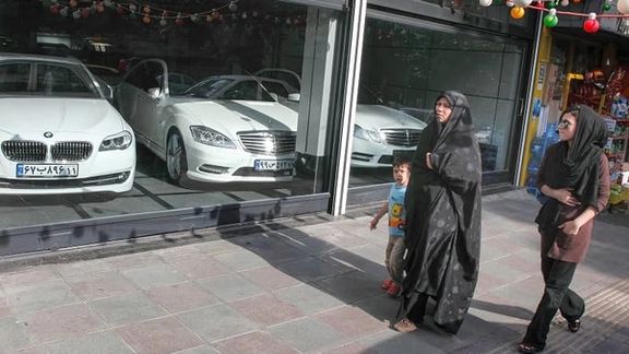 People passing by a shop for luxury cars in Tehran