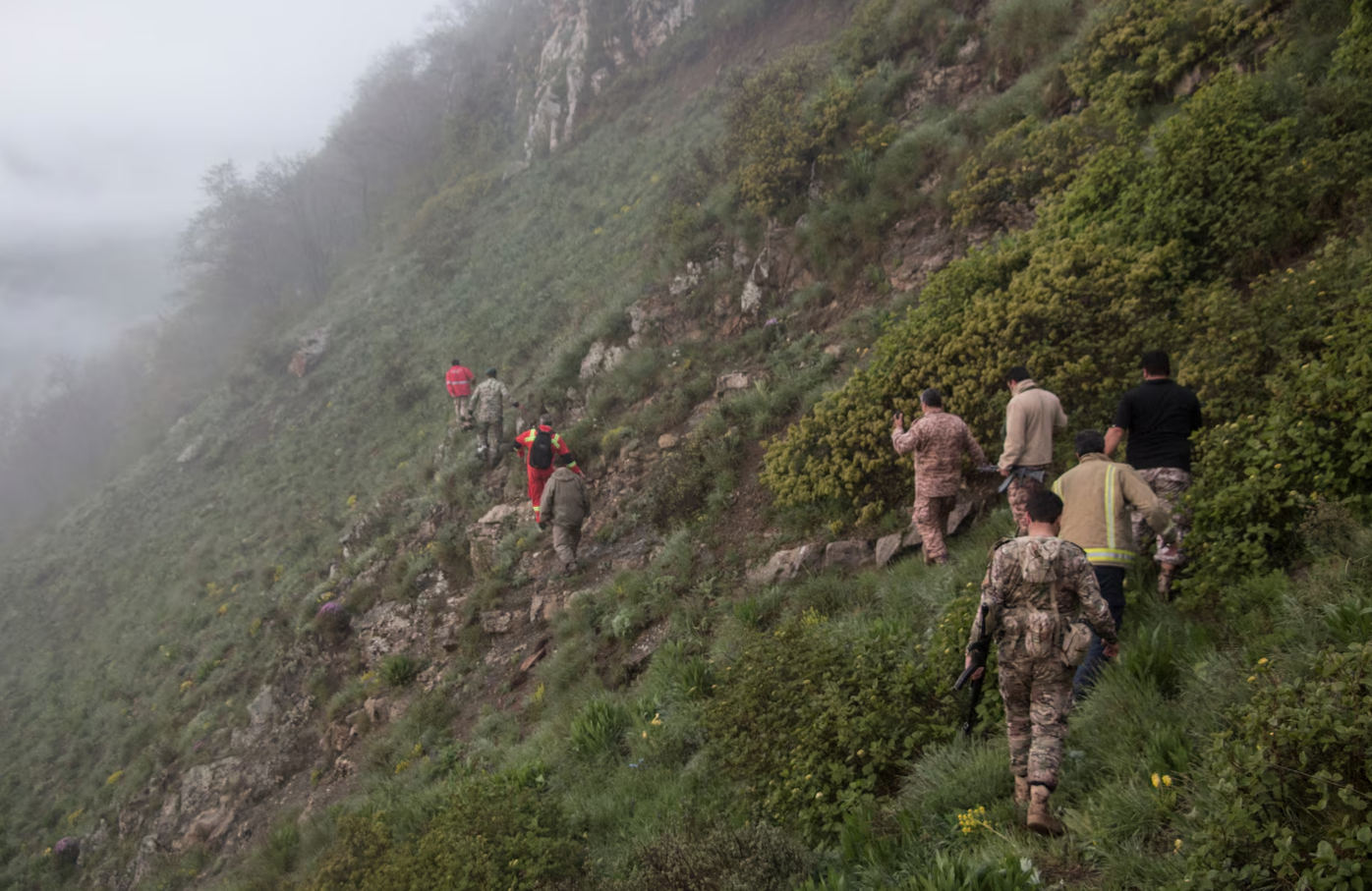 Rescue team members at the scene of the helicopter crash carrying Iran's President Ebrahim Raisi, in Varzaqan, East Azerbaijan Province, Iran