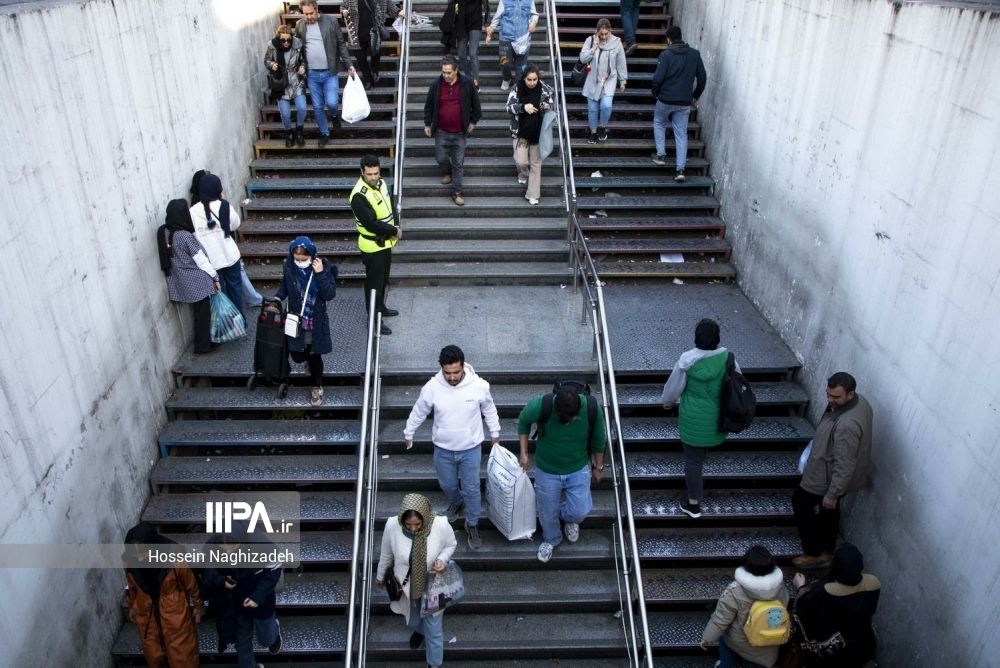 Iranians at the entrance of a subway station in Tehran on March 20, 2024 