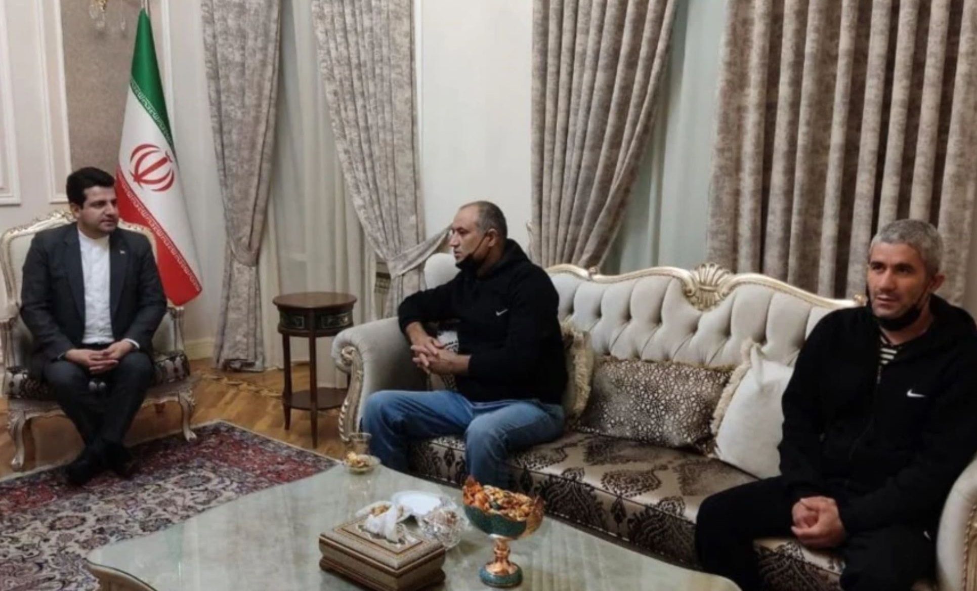 Two Iranian truck drivers seen (C) and (R) in this photo were released by Azerbaijan. October 21, 2021