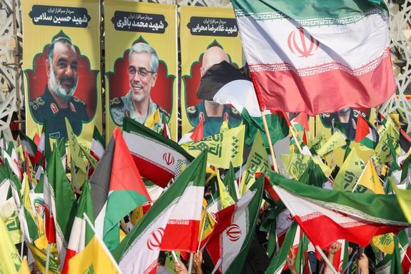 Flags of Iran and its Lebanese ally Hezbollah are waved in front of of posters of Iranian commanders killed by Israeli strikes in a rally to mark one year from the death of Hassan Nasrallah, Tehran, Iran, October 2, 2025
