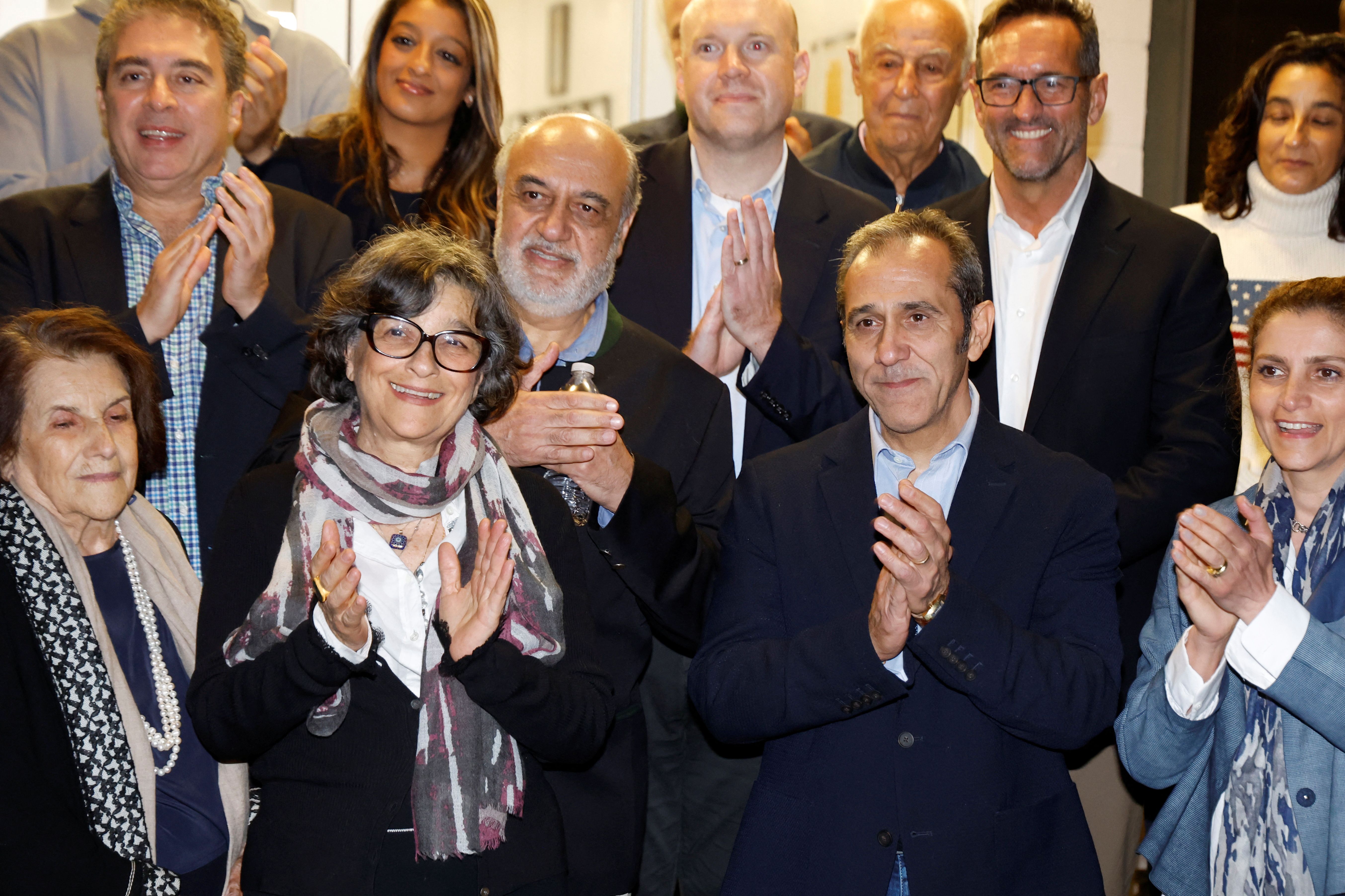 US officials arrange a group photo after freed Iranian-Americans Siamak Namazi, Morad Tahbaz, Emad Shargi, Reza Behrouzi and Fakhr al-Sadat Moeini arrived at Davison Army Airfield at Fort Belvoir, Virginia, September 19, 2023. 