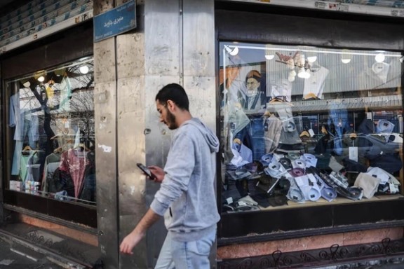A man walks past clothing stores in Tehran, Iran, amid widespread internet disruptions.