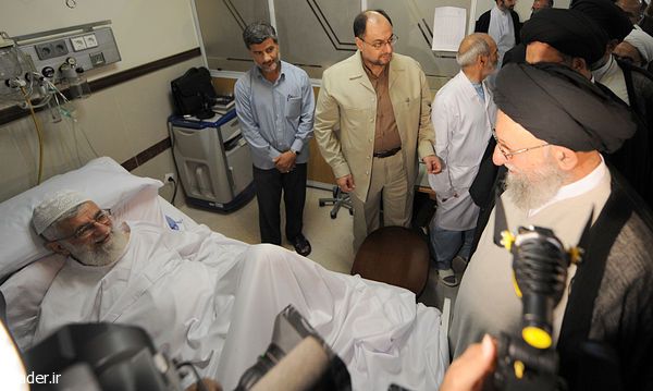 Ayatollah Kazem Nourmfidi, the representative of the Supreme Leader in the northern Golestan province visiting Supreme Leader Ali Khamenei (left) at hospital in 2014  