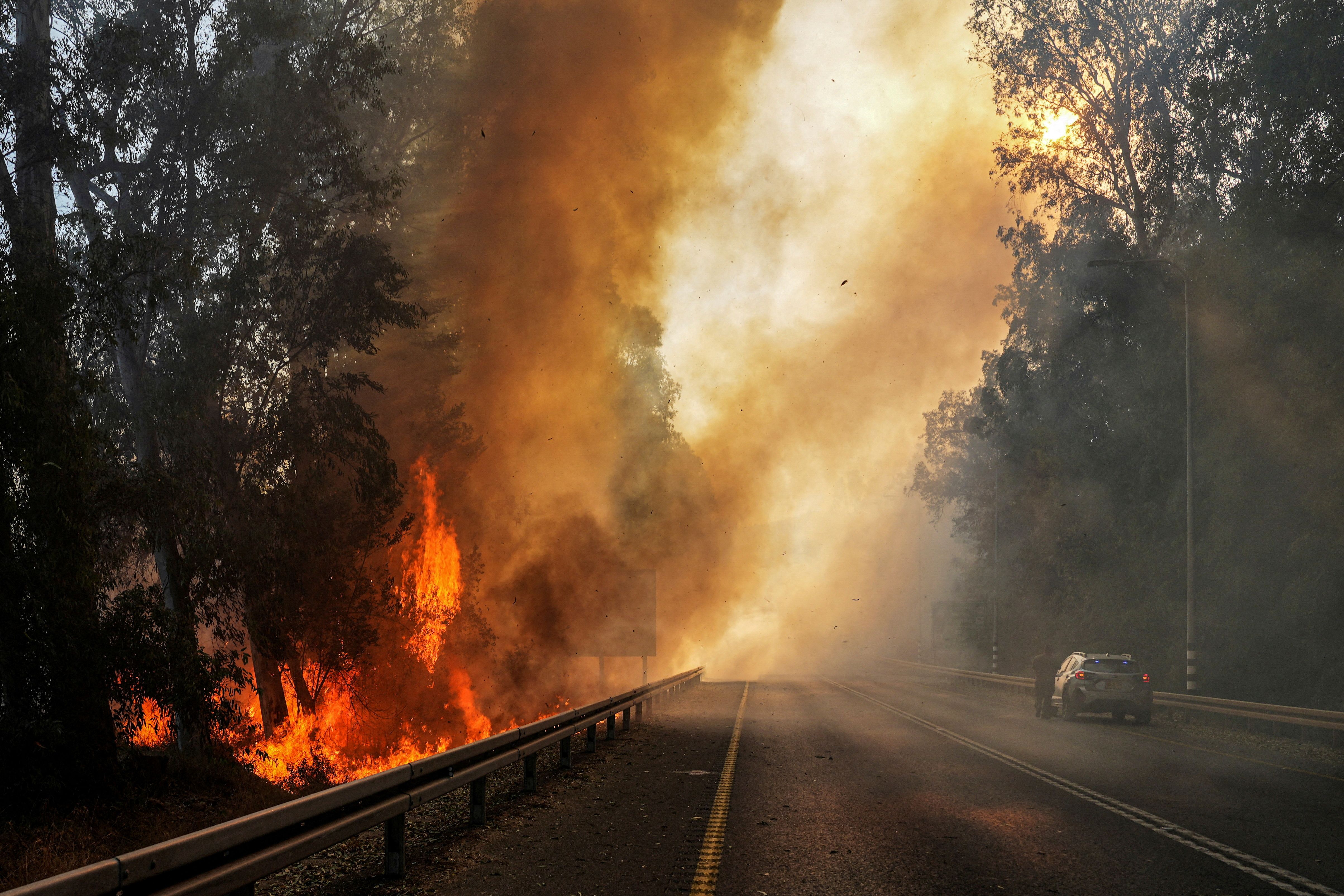 Flames seen at the side of a road, amid ongoing cross-border hostilities between Hezbollah and Israeli forces, close to the Israel border with Lebanon, in northern Israel, June 4, 2024.