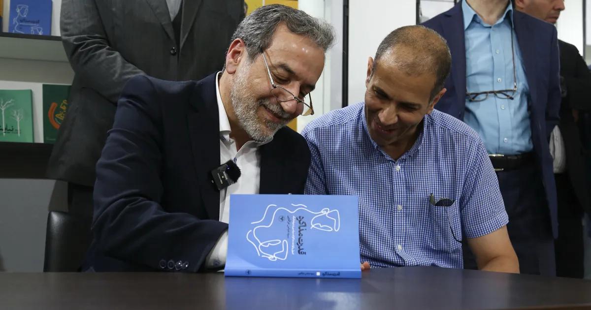 Abbas Araghchi signing a book he wrote after his removal from the Deputy Ministry of Foreign Affairs (Undated)