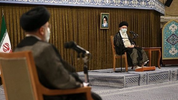 President Ebrahim Raisi listens to Supreme Leader Ali Khamenei during a ceremony
