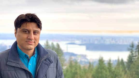 Photo of Mehran Abtahi overlooking Vancouver skyline.