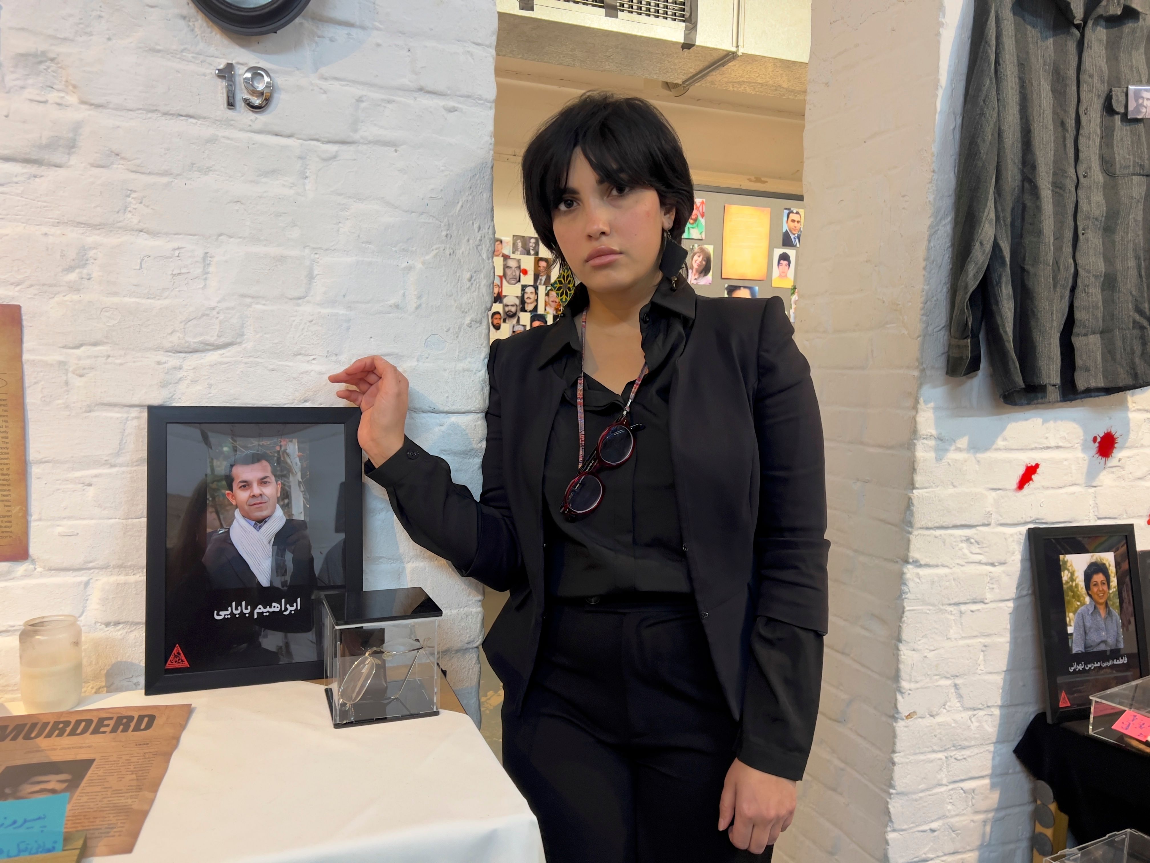 Shima Babaei standing next to her father's glasses