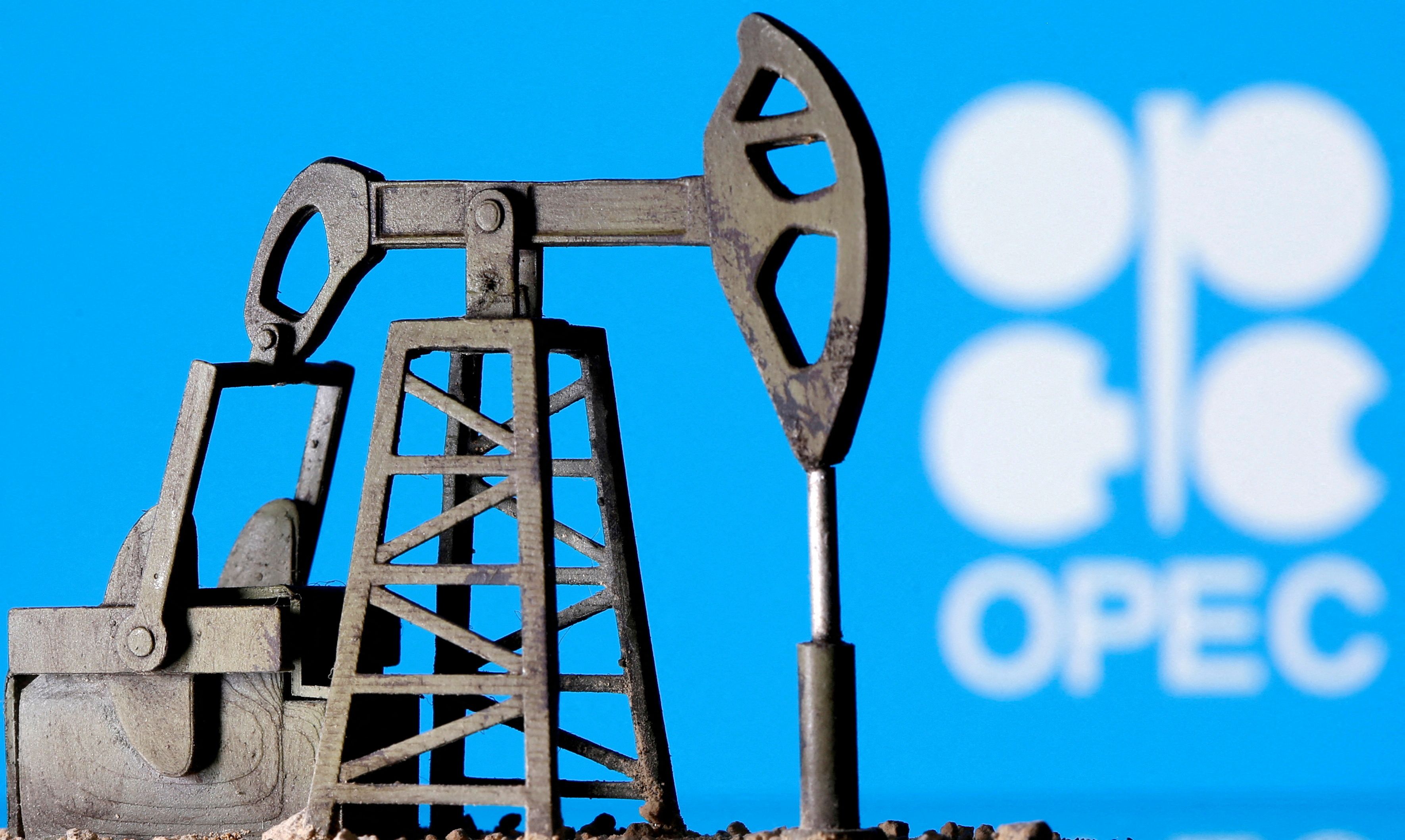 A 3D-printed oil pump jack is seen in front of the OPEC logo in this illustration picture
