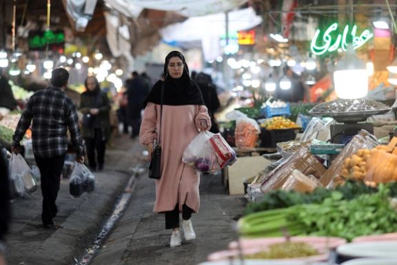 An Iranian woman walks in a local market as the value of the Iranian rial drops, in Tehran, Iran, December 20, 2025.