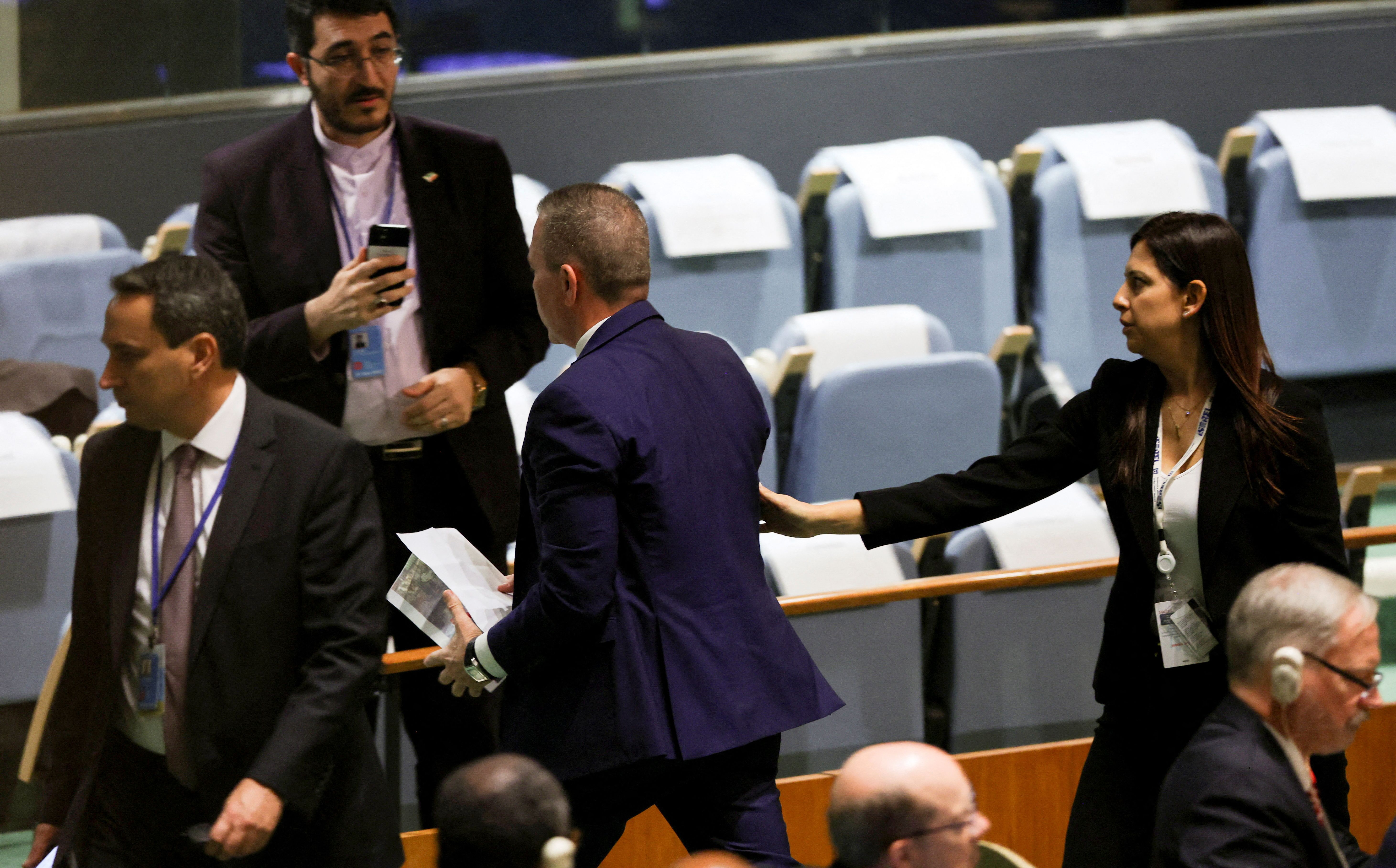 Israel's Ambassador to the United Nations Gilad Erdan is led out of the United Nations General Assembly hall by security officials on September 19, 2023. 