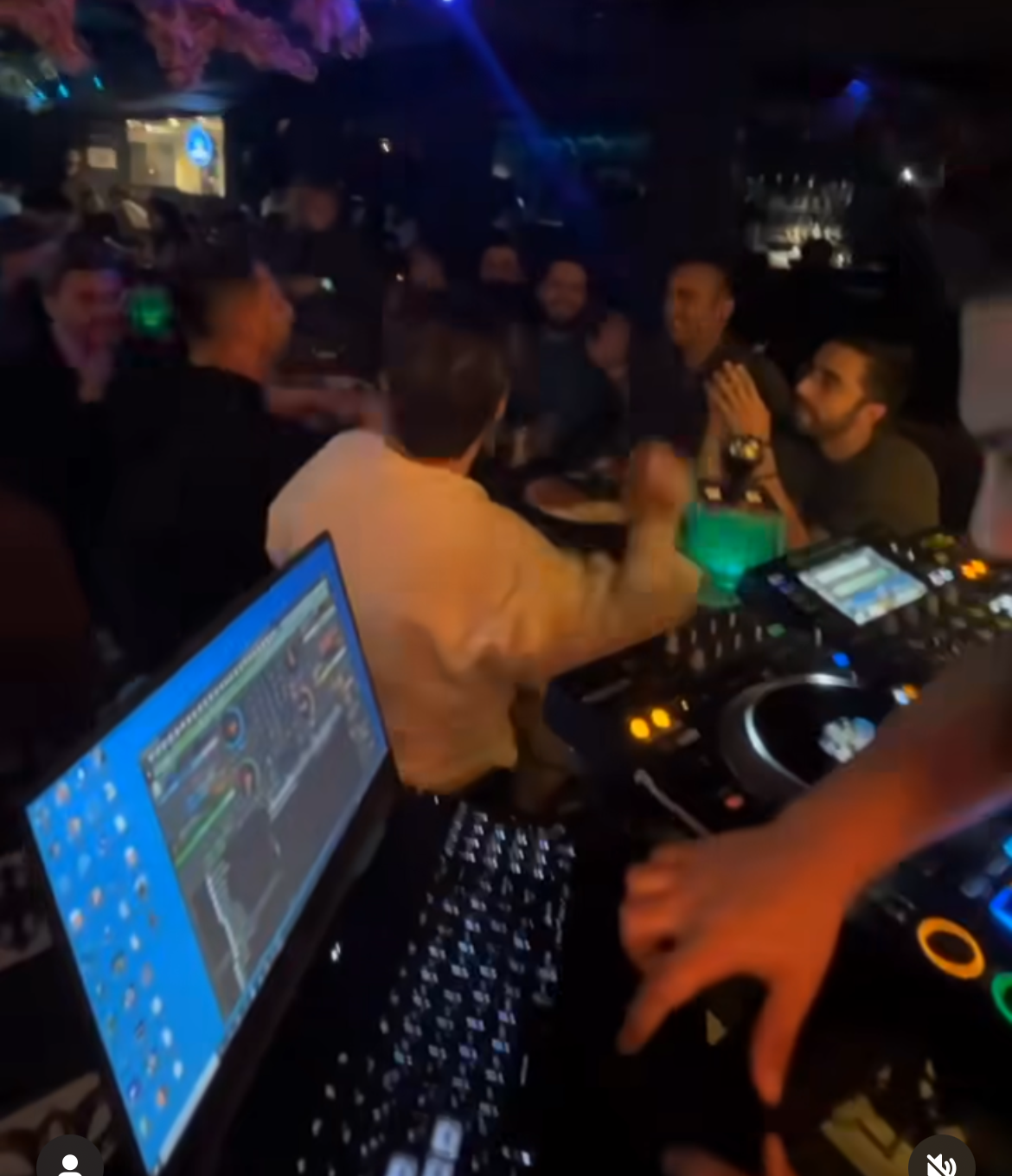 A DJ performs in a night club in Iran