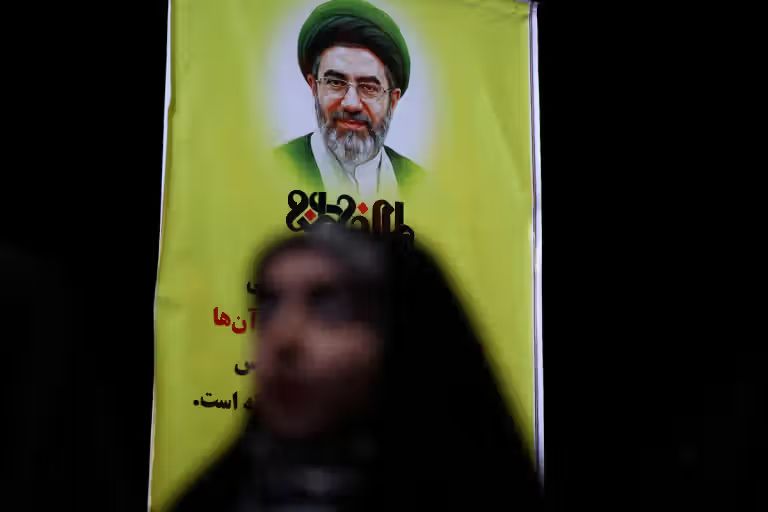 A poster featuring Mojtaba Khamenei on a street in Tehran.