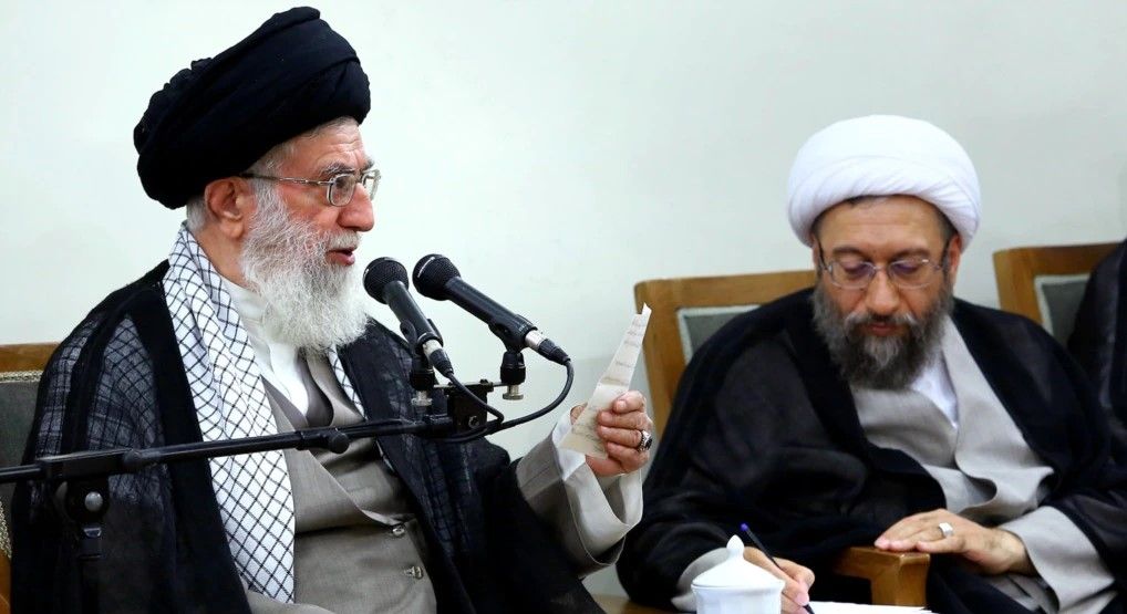 Amoli-Larijani sitting next to Ali Khamenei. Undated