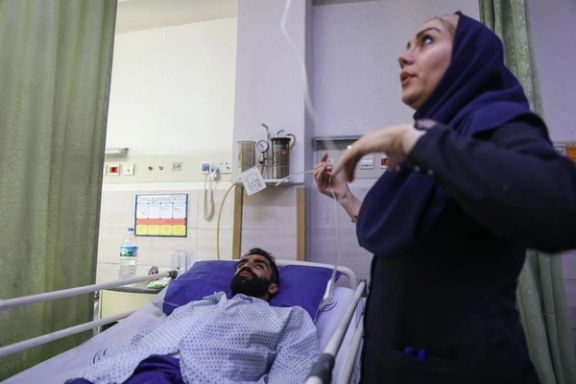 A woman adjusts the medical equipment for a patient at a hospital in Iran in this file photo.
