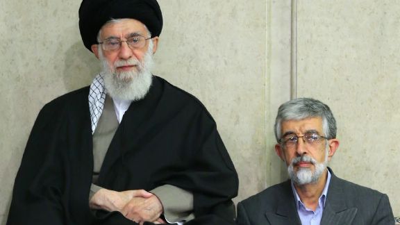 Haddad-Adel sitting next to Khamenei in an undated photo