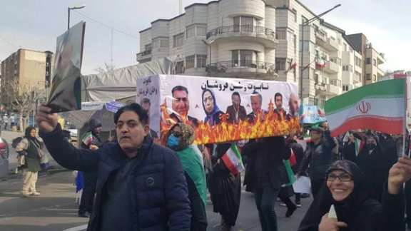 A poster showing opposition leaders burning, during a pro-government march in Tehran on Saturday