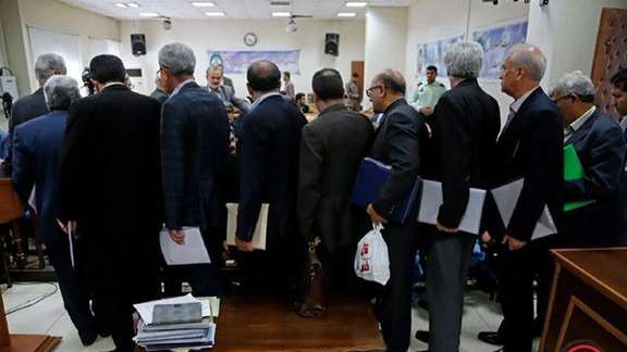 People stand in line inside a bank