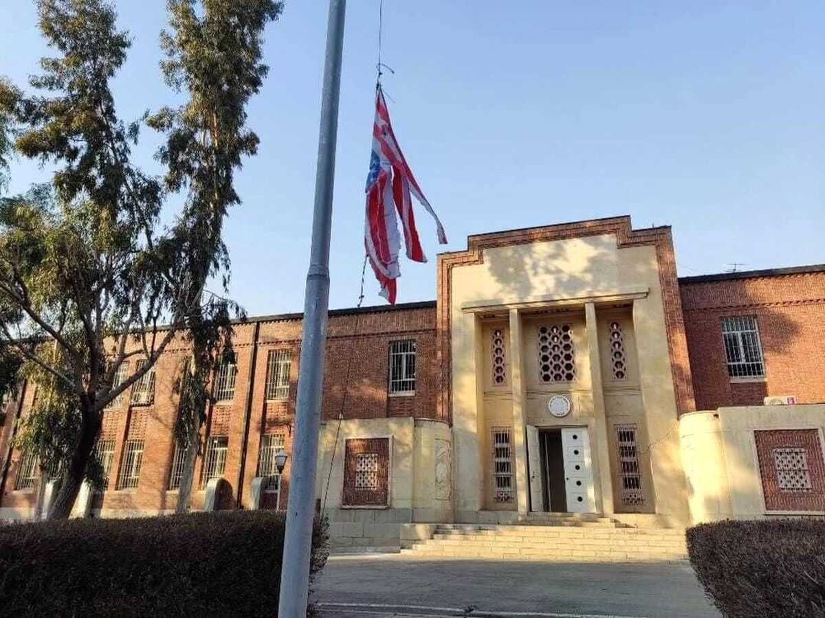 The US embassy in Tehran with a shredded US flag. Undated
