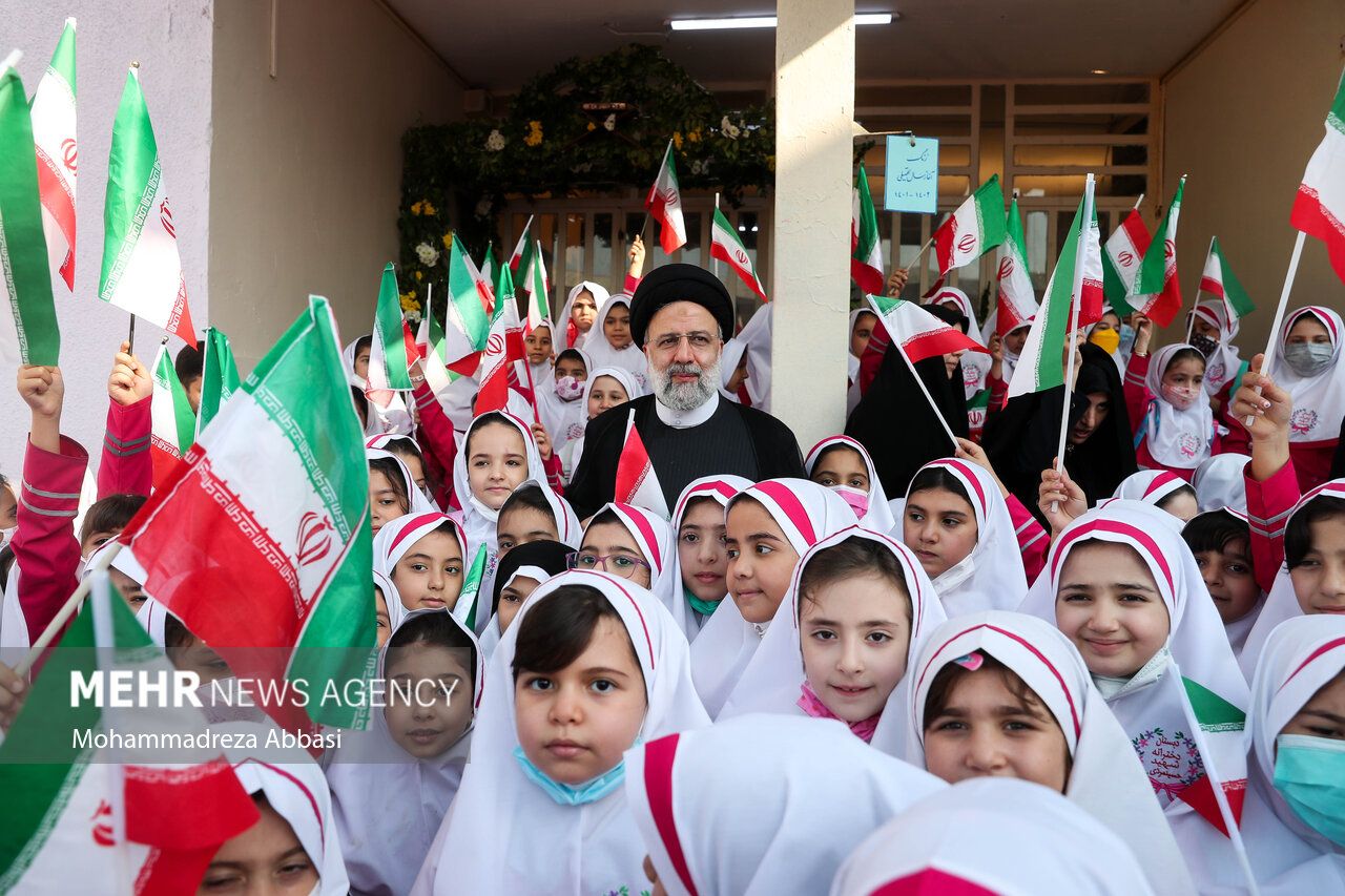 Iran’s President Ebrahim Raisi among a group of schoolgirls in Tehran  