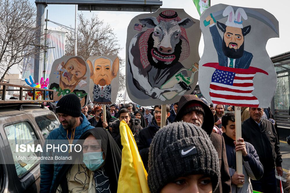People carrying banners mocking (from left) Turkish President Recep Tayyip Erdoğan, Israeli Prime Minister Benjamin Netanyahu, Saudi Prime Minister Mohammed bin Salman Al Saud and Syria's interim leader Ahmed al-Sharaa during rallies to mark the anniversary of the 1979 Islamic Revolution in Iran, February 10, 2024 