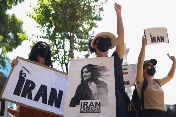 Women hold signs during a protest against the Islamic regime of Iran and following the death of Mahsa Amini, at the Angel of Independence monument in Mexico City, Mexico October 1, 2022.