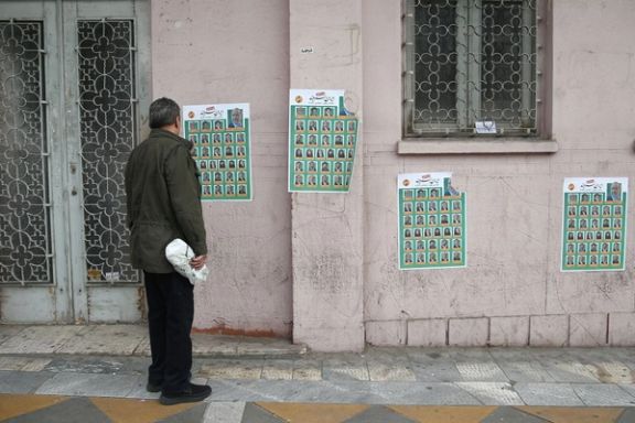A man looks on parliamentary election campaign posters in Tehran, Iran February 19, 2020.