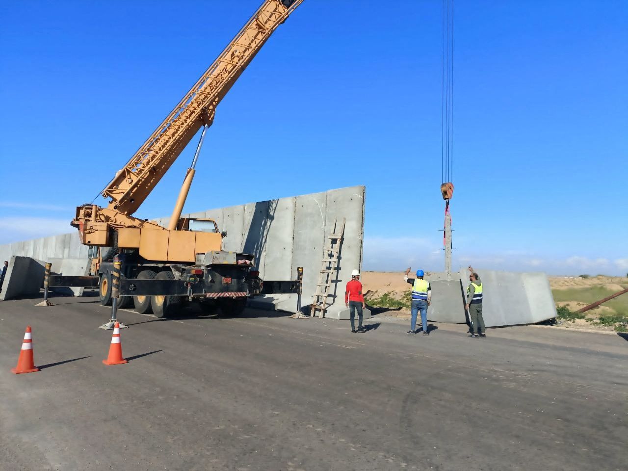 Workers build a large cement fence near the border with Gaza, which Egypt says will be a 'logistics zone' to receive aid for Gaza, amid the ongoing conflict between Israel and Palestinian Islamist group Hamas, in Rafah, Egypt, February 17, 2024.